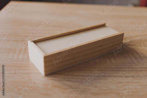 Dominoes in a wooden box on the table