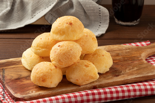 Focus on a pile of cheese bread on cutting board.