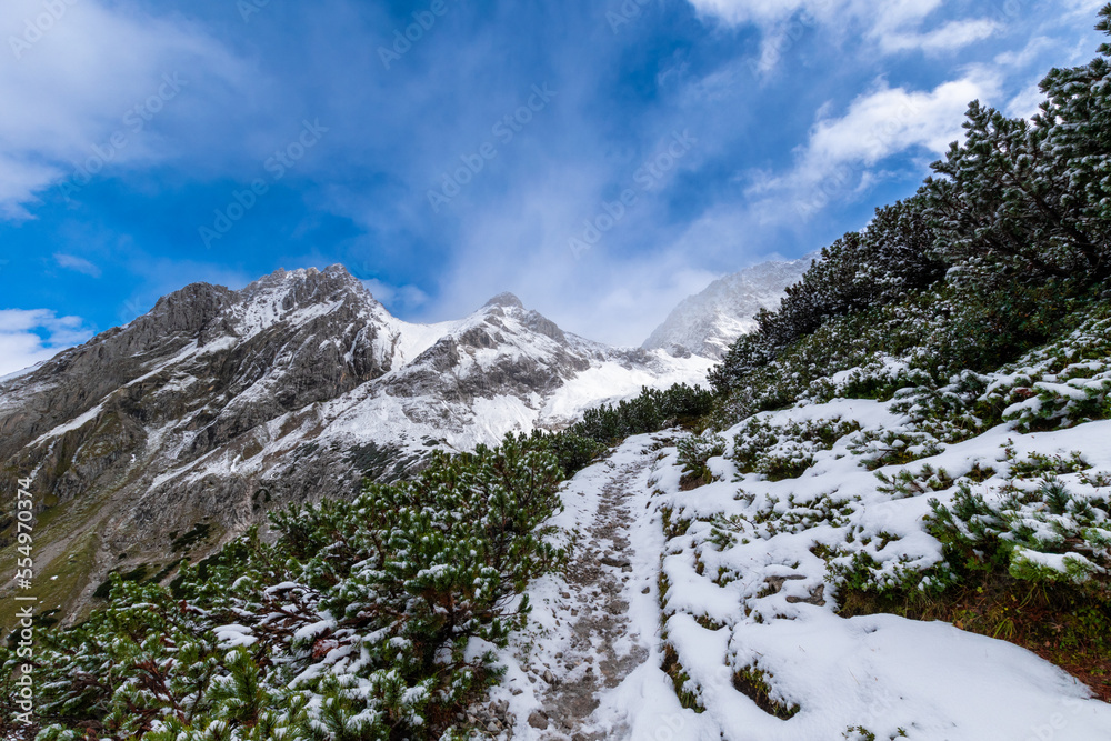 snow covered hiking path during spring (Tyrol, Austria)