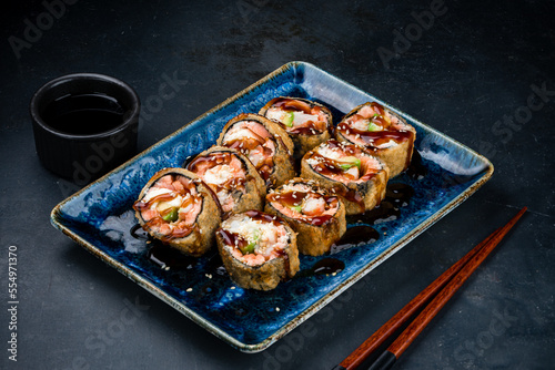 Tempura sushi rolls with shrimp, cream cheese, avocado, sesame and teriyaki sauce.