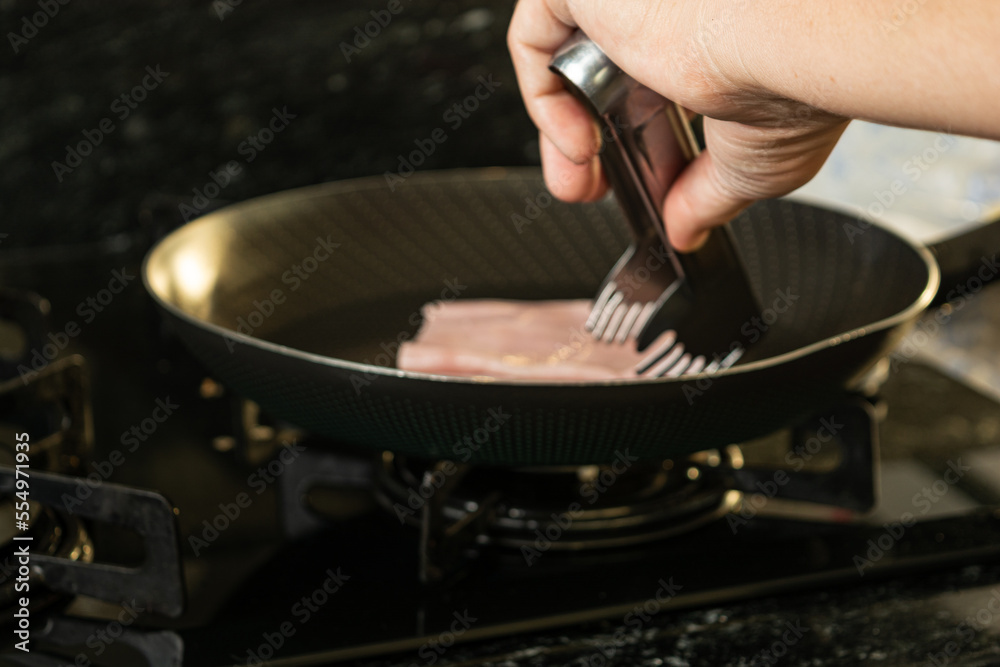 Obraz premium woman preparing hot cheese sandwich on morning breakfast