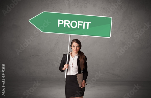 Young business person in casual holding road sign photo