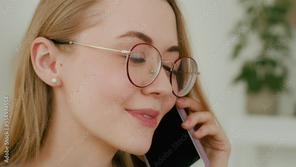 Close up female face smiling businesswoman in glasses answer call. Headshot Caucasian positive woman talking phone with friend share news gossip answering cell communicate girl with smartphone talk Close up female face smiling businesswoman in glasses answer call. Headshot Caucasian positive woman talking phone with friend share news gossip answering cell communicate girl with smartphone talk