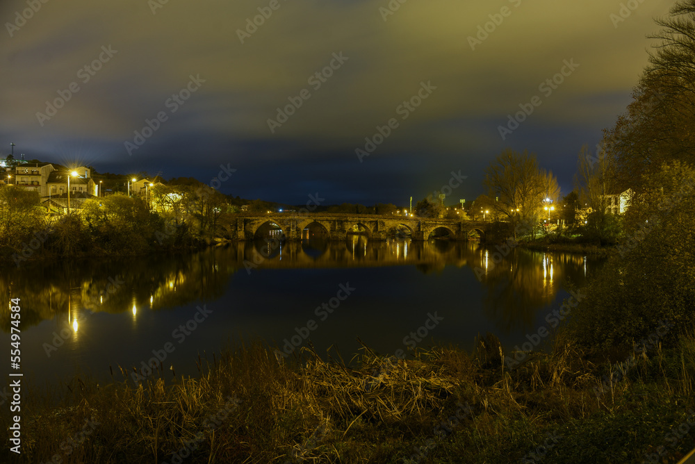 night landscape of the Roman bridge of Lugo over the Minho river