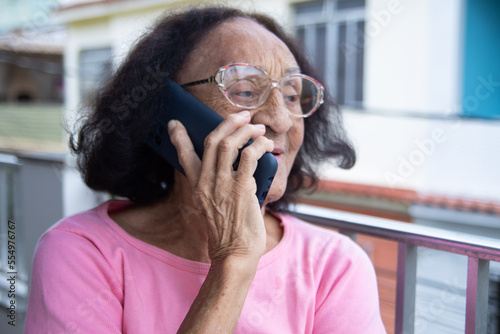Brazilian Senior woman have a conversation on smartphone
