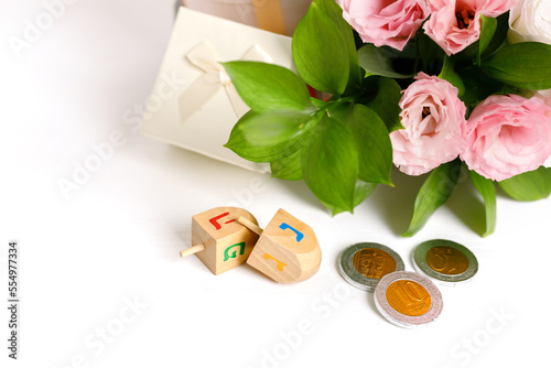 Image of Jewish holiday Hanukkah with donuts  wooden dreidels  spinning top   chocolate coins  flowers and gift wrappings