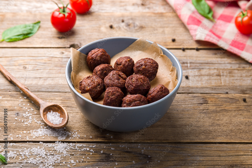 meatballs in bowl on wooden table side view meatballs in bowl on wooden table side view