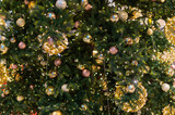 Gold Christmas background of de-focused lights with decorated tree. decorated Christmas tree with golden toys.
