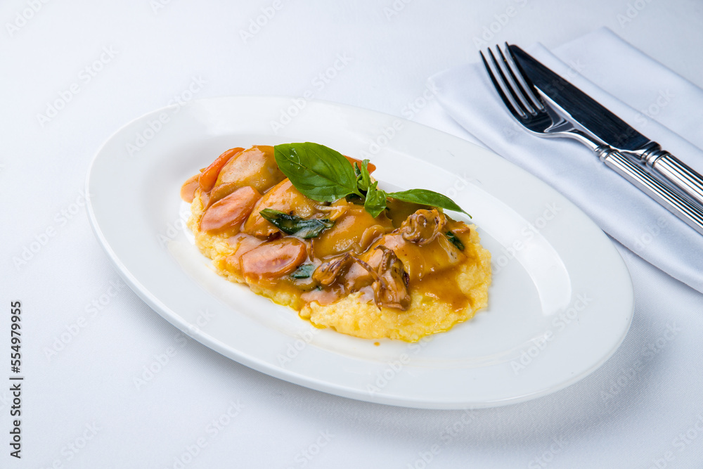 Roasted squid and mashed potatoes on a white plate Roasted squid and mashed potatoes on a white plate