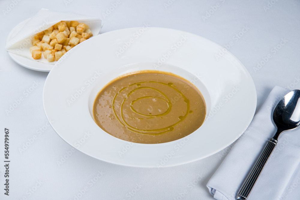 Cream soup of mushrooms on white plate Cream soup of mushrooms on white plate