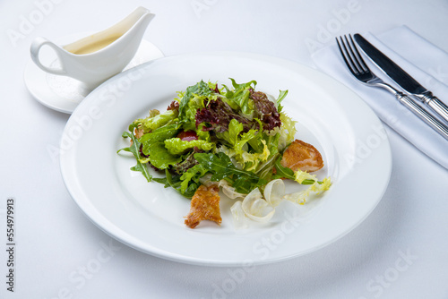 salad with chicken with greenery on a white plate