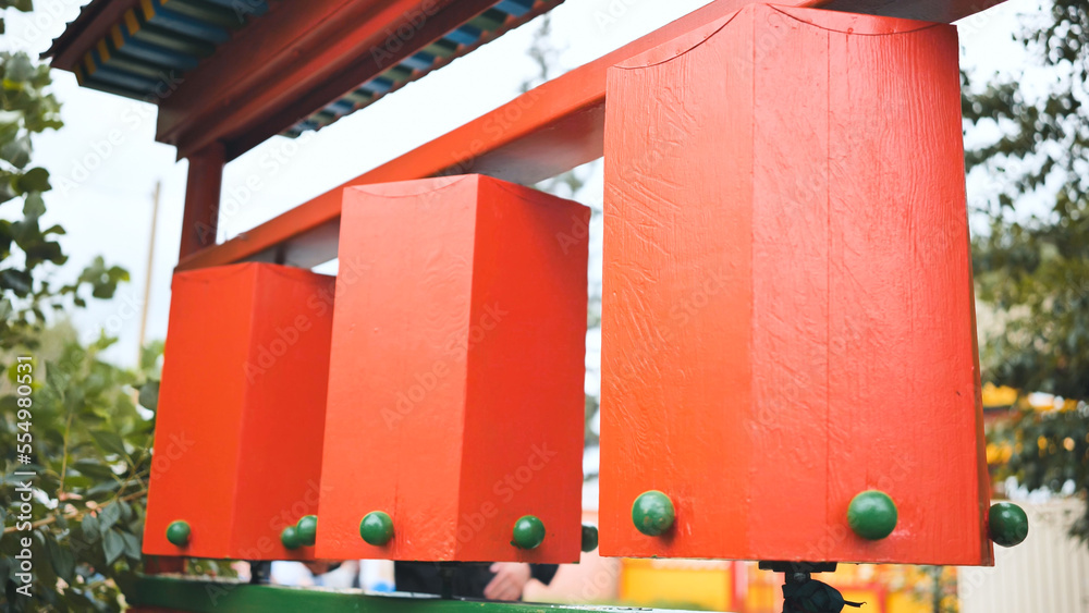 Rotation of the red prayer drums outside the Buddhist temple. Rotation of the red prayer drums outside the Buddhist temple.