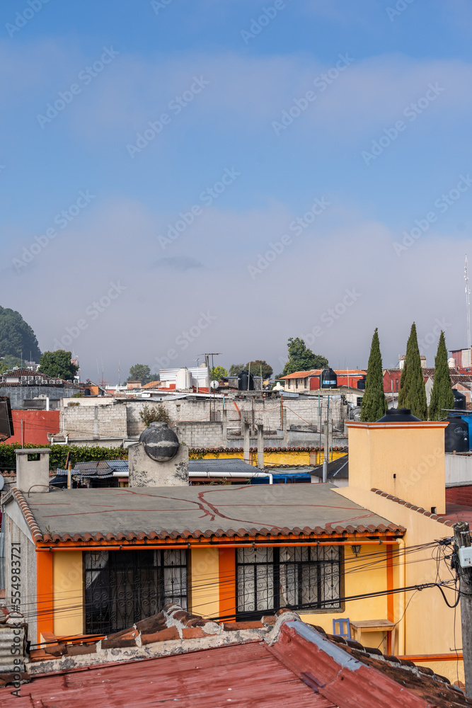 Fototapeta premium Beautiful sunny day in mountain city in Mexico. The famous tiled roofs of the city.