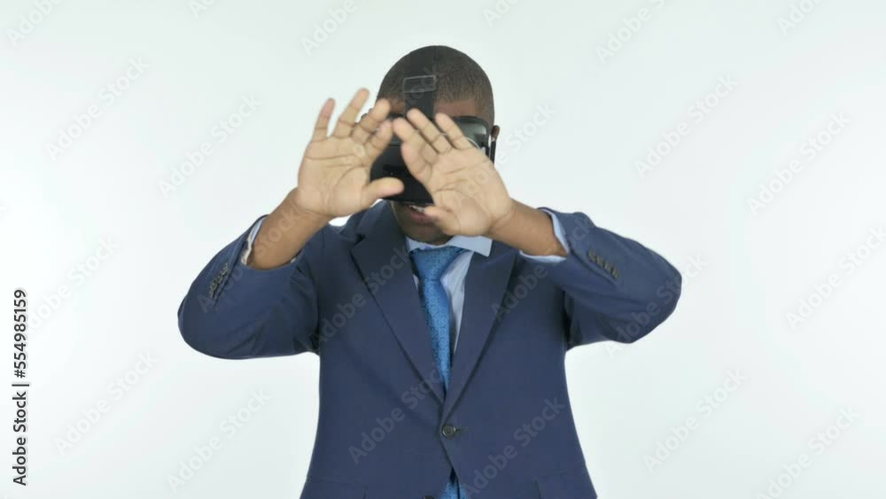 African Businessman Using VR Headset on White Background African Businessman Using VR Headset on White Background