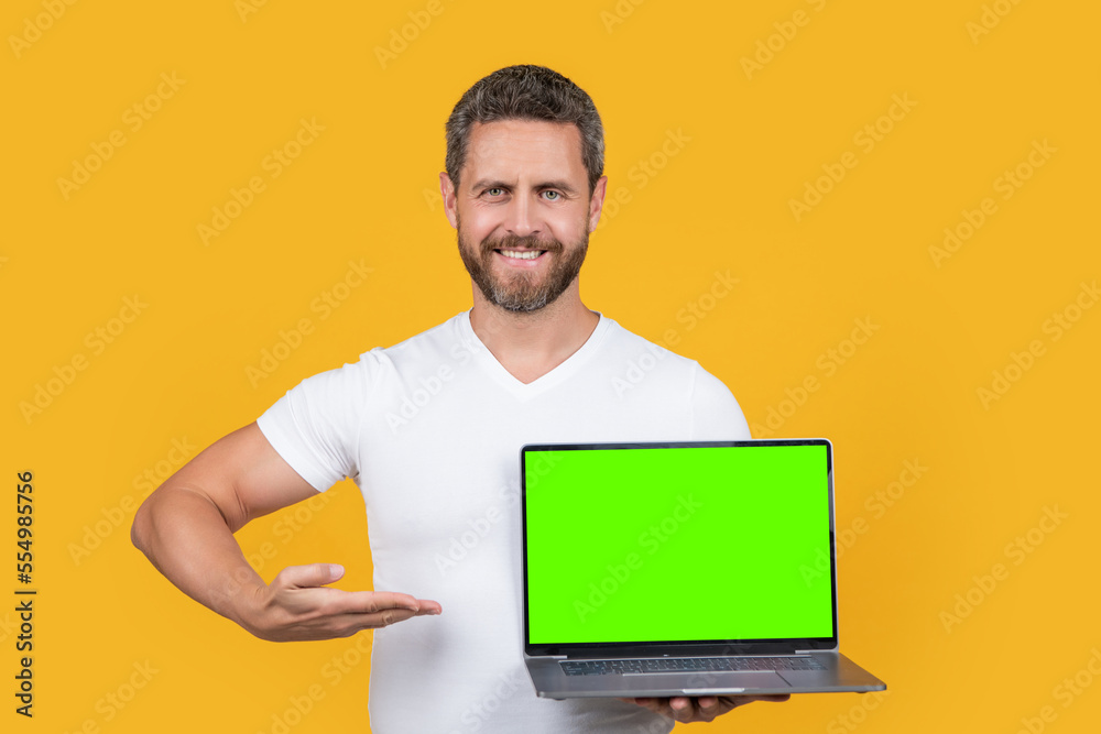 man showing presenting screen with copy space. man showing screen isolated on yellow background. man showing presenting screen with copy space. man showing screen isolated on yellow background.