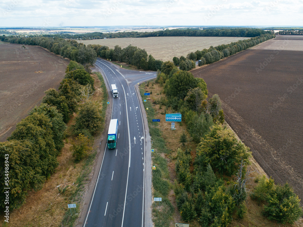 Aerial view asphalt road and green forest, Forest road going through forest with car adventure view from above, Ecosystem and ecology healthy environment concepts and background. Aerial view asphalt road and green forest, Forest road going through forest with car adventure view from above, Ecosystem and ecology healthy environment concepts and background.