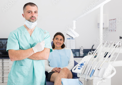 Portrait of professional male dentist with face mask at workplace in dental clinic office