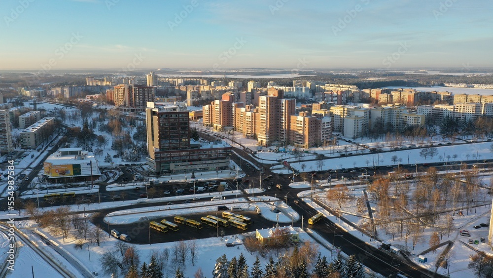 Aerial panoramic view of the Vostok microdistrict in Minsk, the capital of Belarus in winter. Snow-covered outskirts of Minsk. Winter in Eastern Europe. Soviet urban planning architecture.