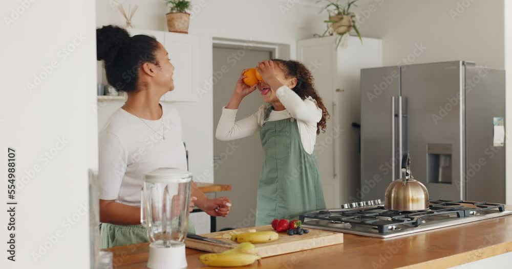 Mother, girl and dance while playing with fruit, having fun and bonding. Care, love and comic, funny and silly mama and child play with bananas and oranges while dancing together in home kitchen. Mother, girl and dance while playing with fruit, having fun and bonding. Care, love and comic, funny and silly mama and child play with bananas and oranges while dancing together in home kitchen.
