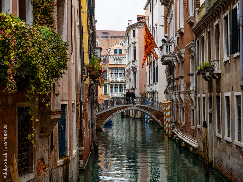 Typical canal of Venice with San Marco flag
