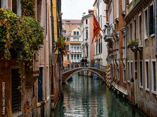 Typical canal of Venice with San Marco flag © Nikokvfrmoto