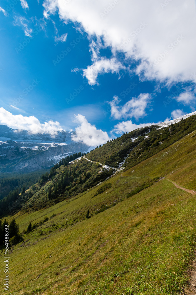 hiking path along the mountain slope during sunshine (Vorarlberg, Austria)