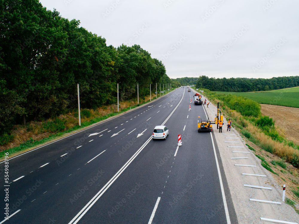 Fototapeta premium Aerial view asphalt road and green forest, Forest road going through forest with car adventure view from above, Ecosystem and ecology healthy environment concepts and background.