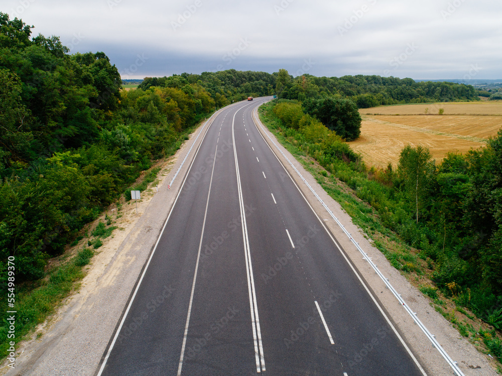 Aerial view asphalt road and green forest, Forest road going through forest with car adventure view from above, Ecosystem and ecology healthy environment concepts and background.