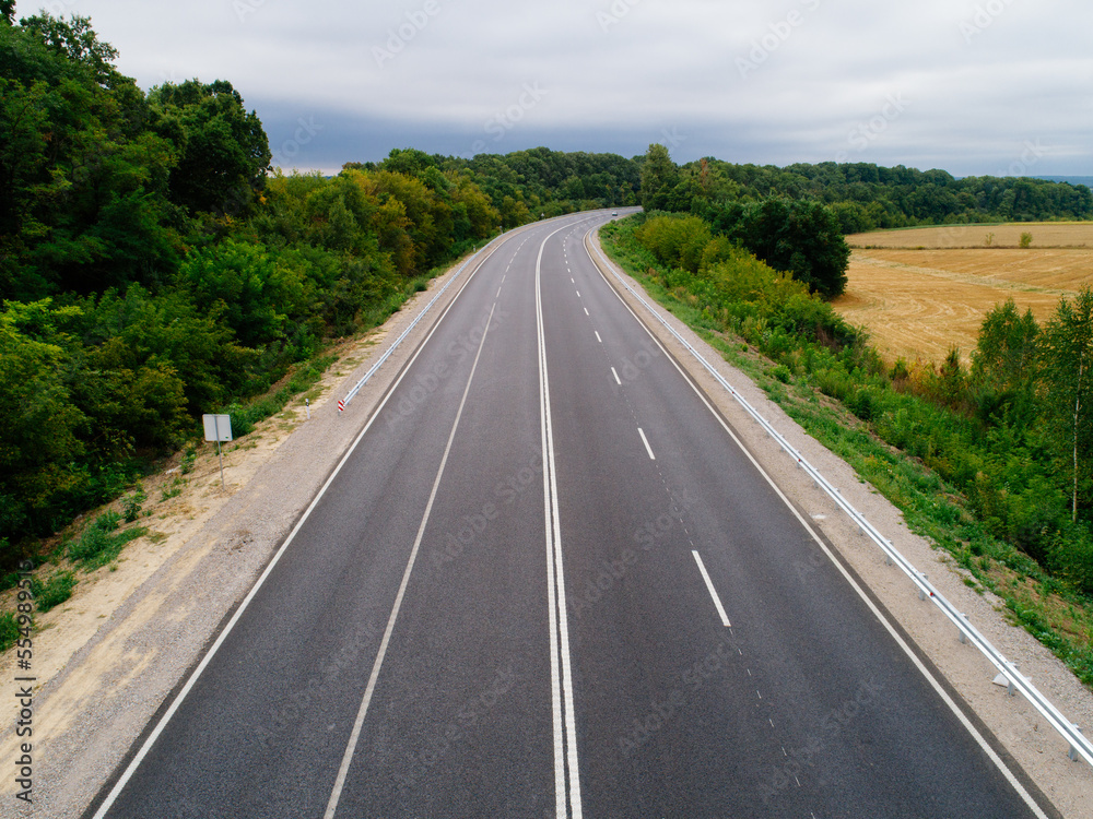 Aerial view asphalt road and green forest, Forest road going through forest with car adventure view from above, Ecosystem and ecology healthy environment concepts and background.