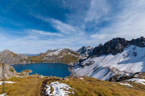 Lünersee in the Austrian Alps with snowy slopes (Vorarlberg, Austria)