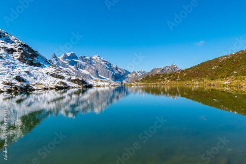 The clear tarn reflects the surrounding alpine panorama  Tobelsee  Vorarlberg  Austria 