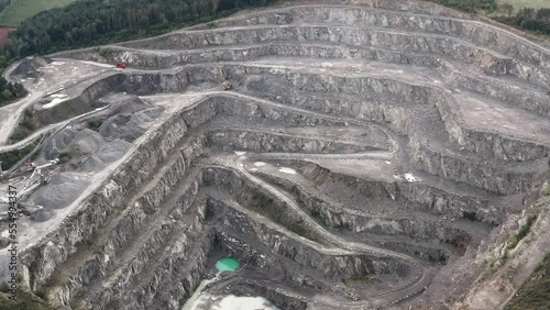 Aerial view of deep granite quarry, heavy industry