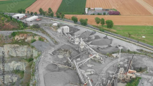Aerial view of many conveyor belts in a quarry sorting rocks and rubble into piles in a quarry
