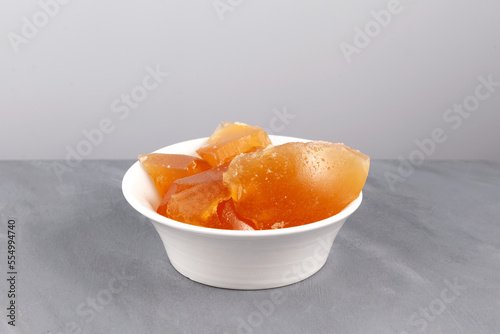 Chilled jelly-like beef broth. Jelly made from boiled beef bones in white bowl, close-up. Meat bouillon contains natural collagen for joint health photo