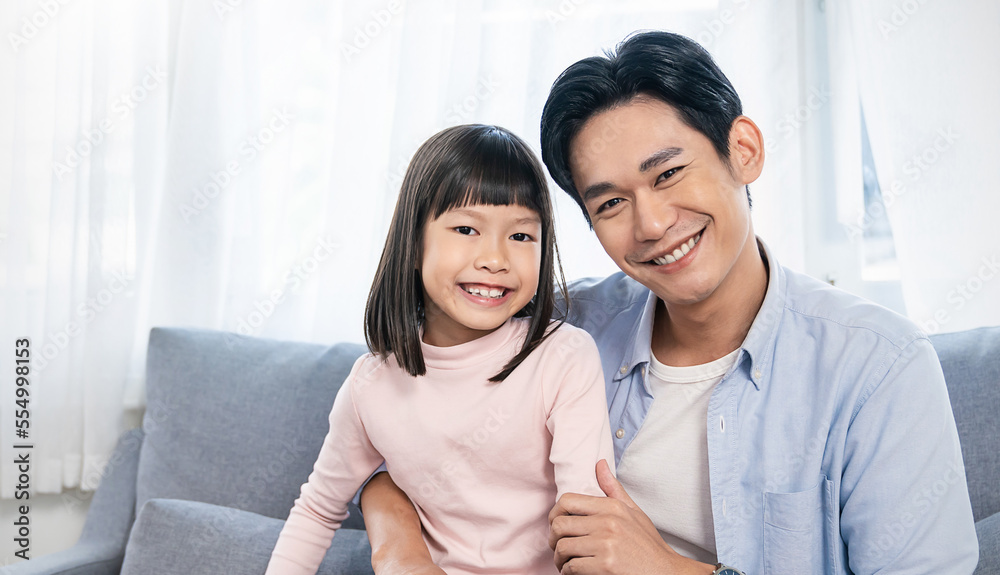 Portrait of happy asian father daughter playing at home living room. Asia man sit withlittle toddler girl. Cheerful family bonding together father’s day concept banner with copy space Portrait of happy asian father daughter playing at home living room. Asia man sit withlittle toddler girl. Cheerful family bonding together father’s day concept banner with copy space