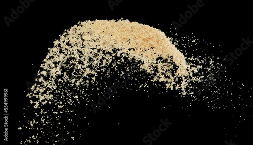 Brown Sugar flying explosion, brown grain sugar explode abstract cloud fly. Beautiful complete seed sugarcane splash in air, food object design. Selective focus freeze shot Black background isolated