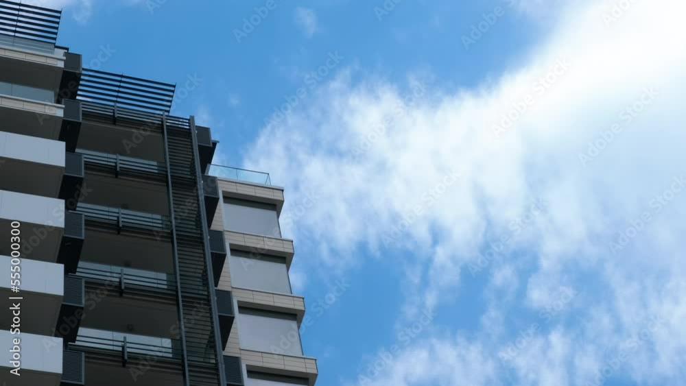 New modern black and white apartment building. View of a modern apartment building from below against the sky. New modern black and white apartment building. View of a modern apartment building from below against the sky.