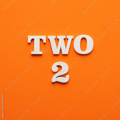 Two phrase in white letters on orange foamy background