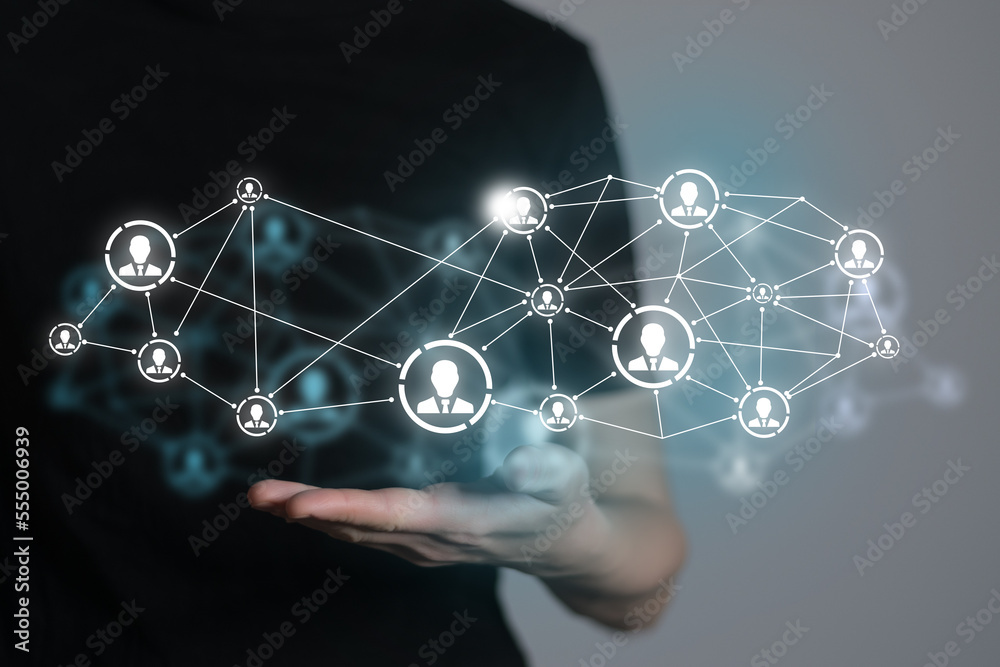 Human resources manager pointing at virtual network chain with person icons. Human capital and teambuilding concept. Human resources manager pointing at virtual network chain with person icons. Human capital and teambuilding concept.