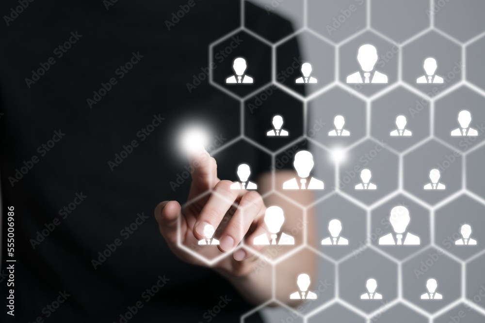 Human resources manager pointing at virtual network chain with person icons. Human capital and teambuilding concept. Human resources manager pointing at virtual network chain with person icons. Human capital and teambuilding concept.