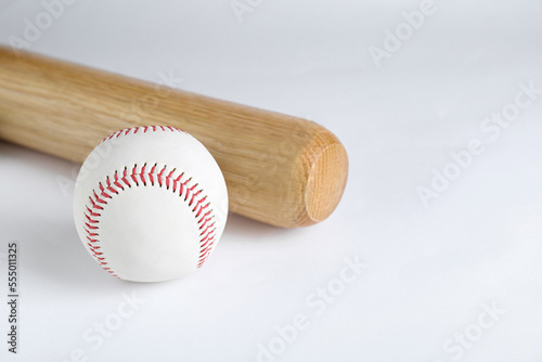 Wooden baseball bat and ball on white background. Sports equipment