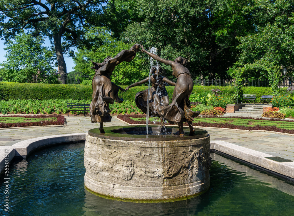 New York, NY - USA - July 20, 2018 Horizontal view of Central Park Conservatory Garden’s bronze memorial fountain, Untermyer Fountain. The Three Dancing Maidens, was designed by Walter Schott.