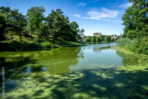 New York, NY - USA - July 20, 2018 Wide angle view of scenic Harlem Meer, a man-made lake at the northeast corner of New York City's Central Park. A popular destination. photo