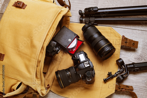 professional DSLR camera and lenses in a canvas bag for the work of a professional photographer