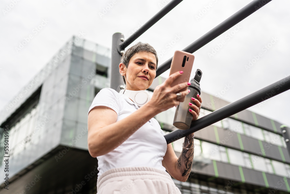 mature caucasian senior woman take a brake during outdoor training