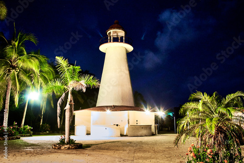 lighthouse at night with palm trees around in coyuca lagoon in pie de la cuesta, acapulco guerrero  photo