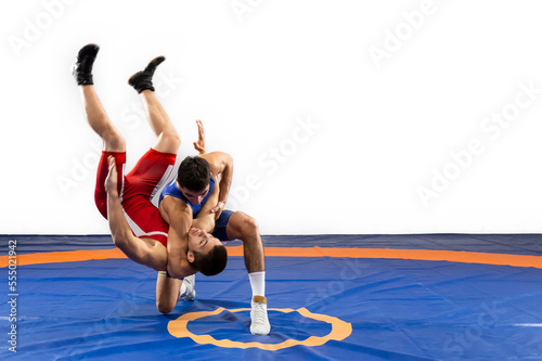 The concept of fair wrestling. Two greco-roman  wrestlers in red and blue uniform wrestling   on a wrestling carpet photo