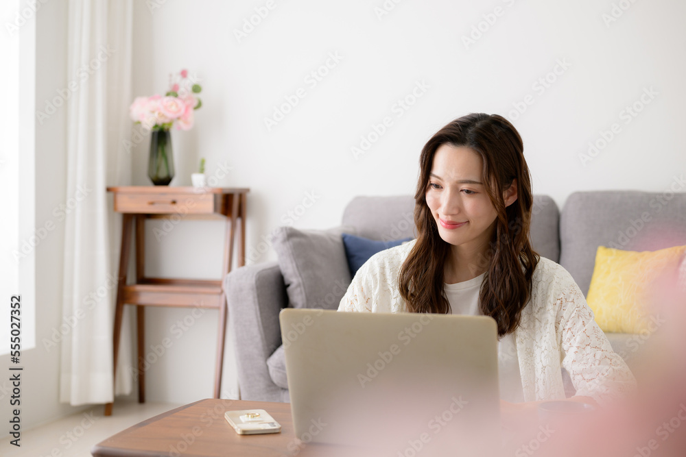 Woman working at computer, with pink foreground blur Woman working at computer, with pink foreground blur