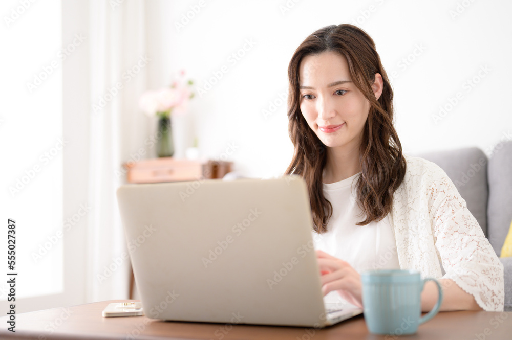 Young woman thinking while looking at a computer Young woman thinking while looking at a computer