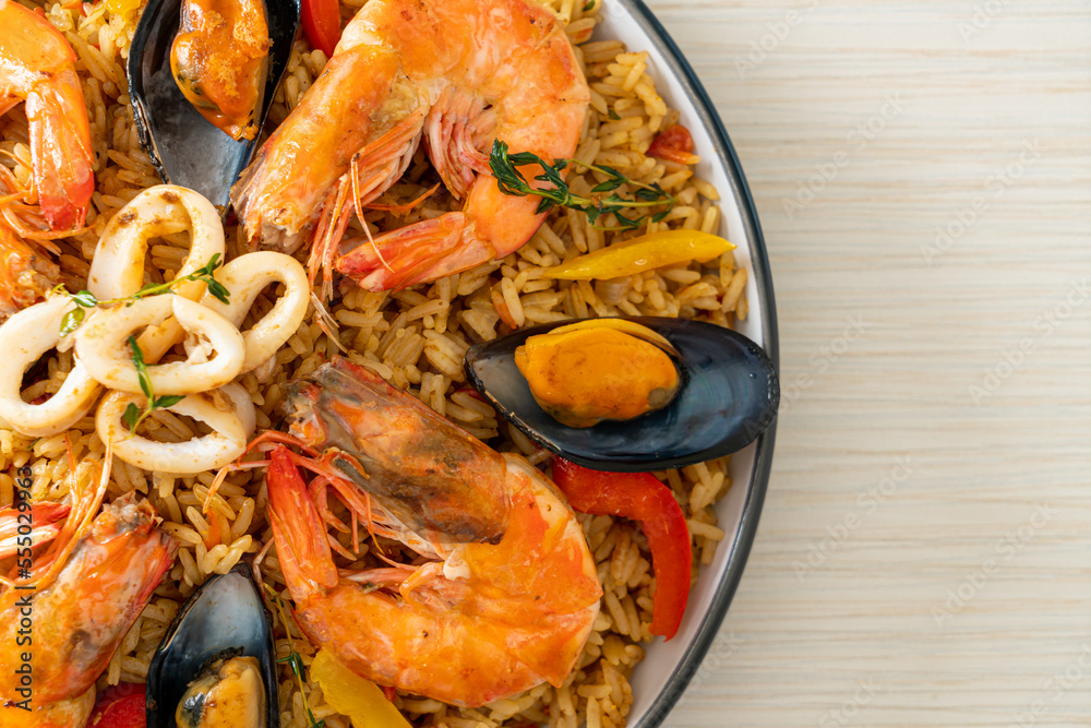 Seafood Paella with prawns, clams, mussels on saffron rice Seafood Paella with prawns, clams, mussels on saffron rice